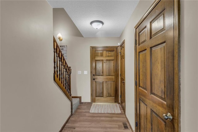 205 N 1700th Rd, Lecompton, KS 66050 - foyer featuring light wood-style floors, stairway, baseboards, and a textured ceiling