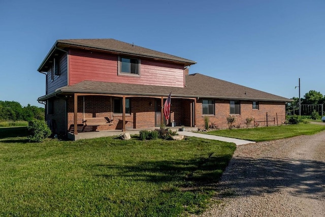 205 N 1700th Rd, Lecompton, KS 66050 - view of front of house featuring brick siding, a front yard, and a porch