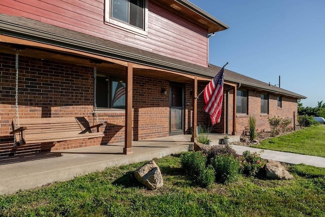205 N 1700th Rd, Lecompton, KS 66050 - doorway to property featuring brick siding and a lawn
