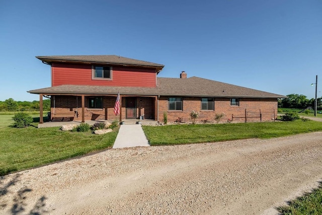 205 N 1700th Rd, Lecompton, KS 66050 - view of front of property with a front lawn, brick siding, and a chimney
