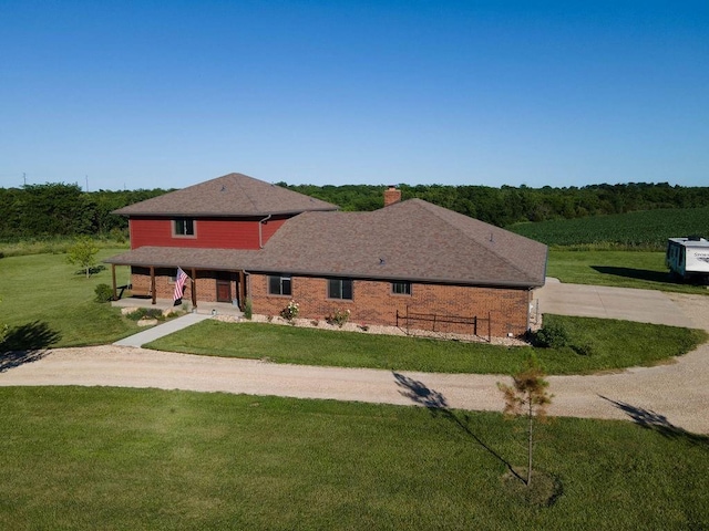 205 N 1700th Rd, Lecompton, KS 66050 - view of front of home with concrete driveway, a chimney, brick siding, and a porch