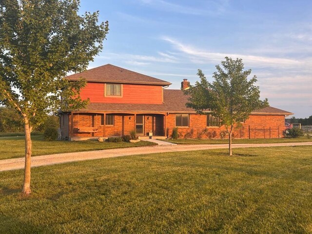 205 N 1700th Rd, Lecompton, KS 66050 - traditional-style home with a chimney, a front yard, brick siding, and a shingled roof