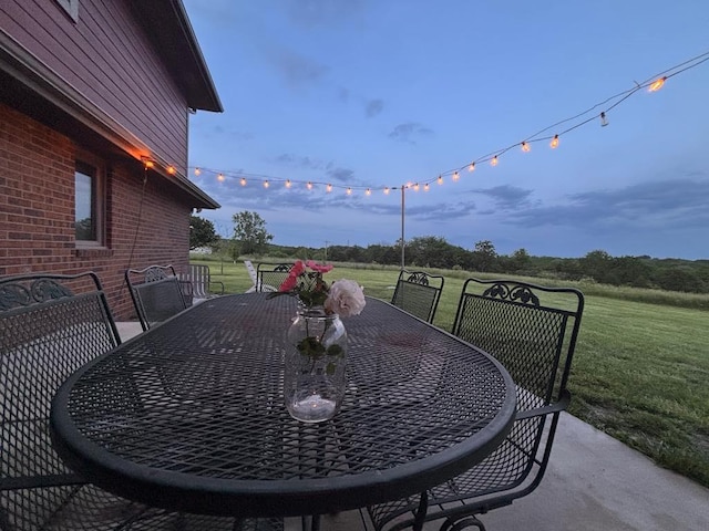 205 N 1700th Rd, Lecompton, KS 66050 - patio terrace at dusk with outdoor dining area and a yard