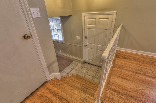 entryway with baseboards and light tile patterned floors