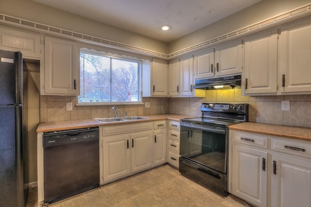 kitchen with a sink, light countertops, under cabinet range hood, black appliances, and backsplash