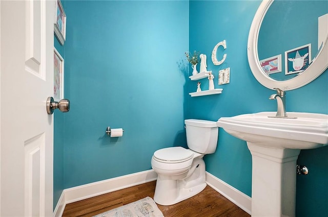 5484 NE Northgate Xing, Lees Summit, MO 64064 - half bathroom featuring toilet, baseboards, and wood finished floors