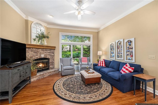 5484 NE Northgate Xing, Lees Summit, MO 64064 - living area with ornamental molding, ceiling fan, a fireplace, wood finished floors, and baseboards