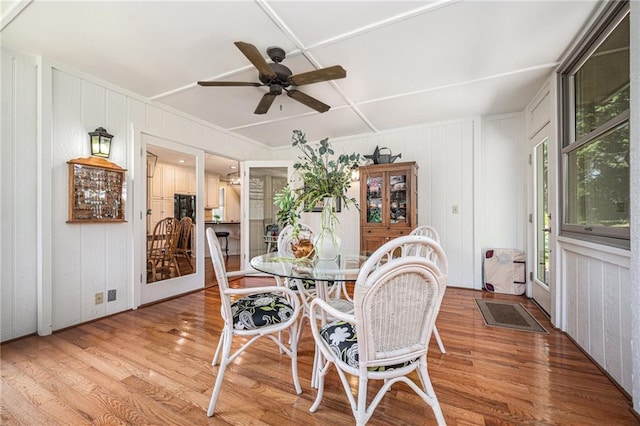 5484 NE Northgate Xing, Lees Summit, MO 64064 - dining room featuring a ceiling fan, a decorative wall, and wood finished floors