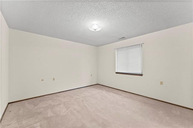 501 N Stone Blvd, Raymore, MO 64083 - empty room with baseboards, carpet flooring, and a textured ceiling
