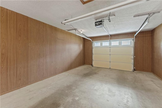 501 N Stone Blvd, Raymore, MO 64083 - garage with wooden walls and a garage door opener