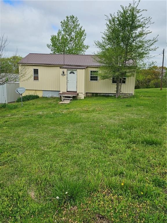30740 W 83rd St, De Soto, KS 66018 - back of property featuring metal roof, a yard, and entry steps