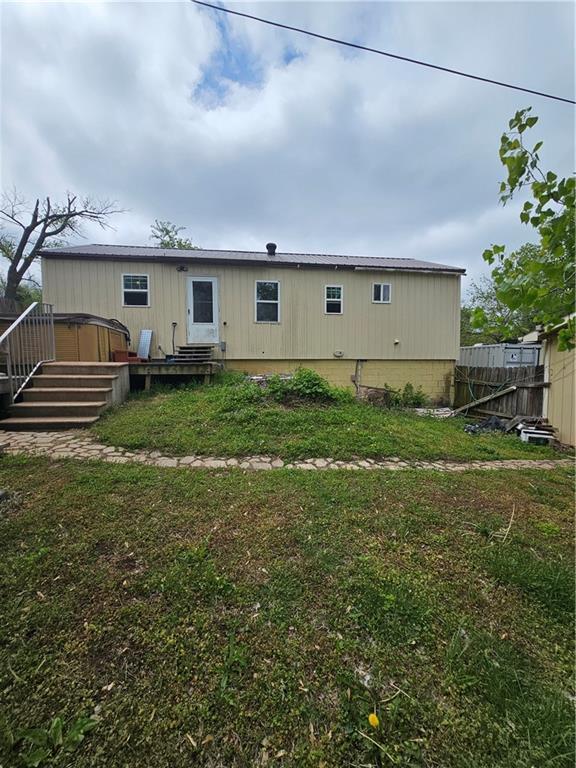 30740 W 83rd St, De Soto, KS 66018 - back of property featuring a lawn, a wooden deck, and fence