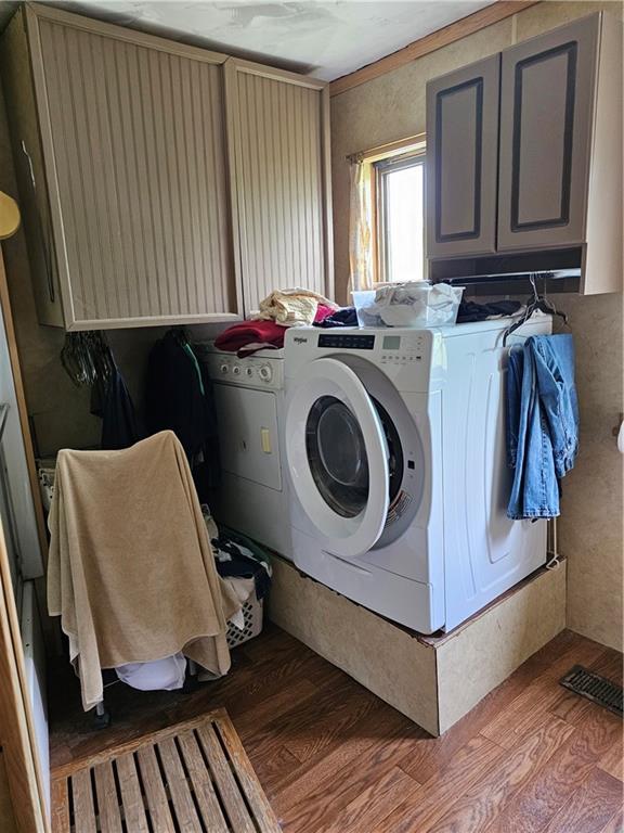 30740 W 83rd St, De Soto, KS 66018 - laundry area with wood finished floors, cabinet space, and independent washer and dryer