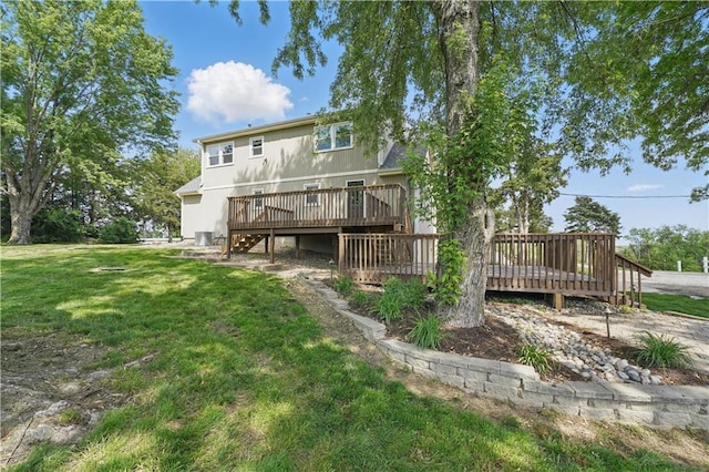 5700 N 123rd St, Kansas City, KS 66109 - rear view of house with a wooden deck and a lawn