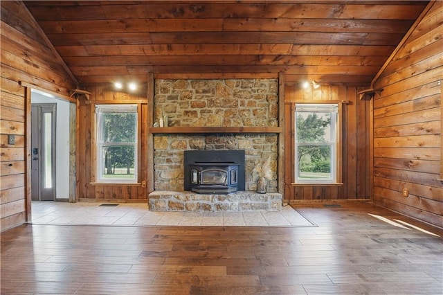 5700 N 123rd St, Kansas City, KS 66109 - unfurnished living room with lofted ceiling, wood ceiling, hardwood / wood-style floors, wooden walls, and a wood stove