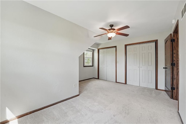 5700 N 123rd St, Kansas City, KS 66109 - unfurnished bedroom with multiple closets, light carpet, baseboards, and a ceiling fan