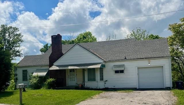 4748 Eastern Ave, Kansas City, MO 64129 - view of front facade featuring a garage, a chimney, a front lawn, and driveway