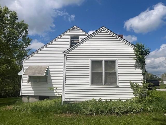 4748 Eastern Ave, Kansas City, MO 64129 - view of home's exterior with a chimney