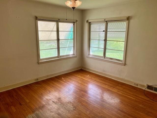 4748 Eastern Ave, Kansas City, MO 64129 - spare room with wood-type flooring and baseboards