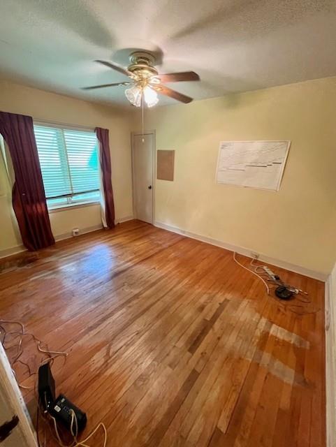4748 Eastern Ave, Kansas City, MO 64129 - spare room with light wood-style flooring, ceiling fan, and baseboards