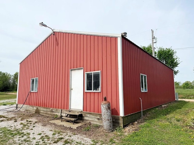 view of outdoor structure featuring entry steps and an outbuilding