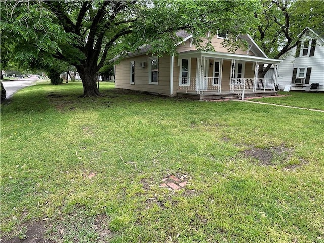 view of front of house with covered porch and a front yard