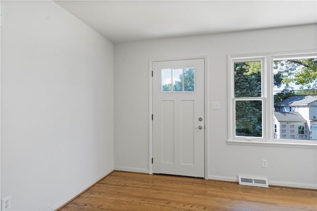 entrance foyer featuring visible vents, baseboards, and wood finished floors