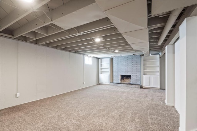 below grade area featuring carpet flooring and a brick fireplace