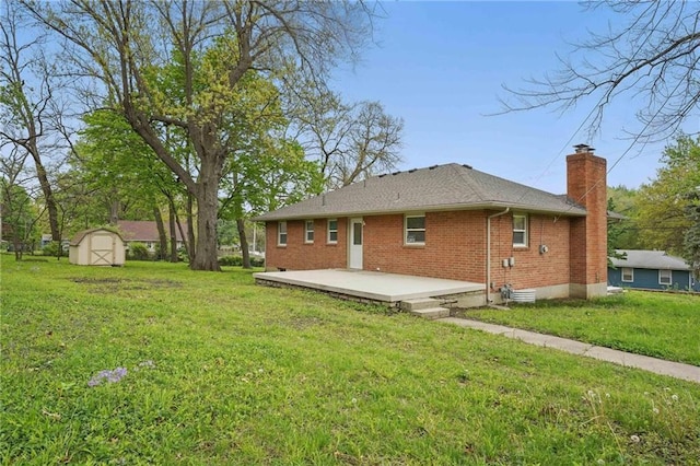 rear view of house with brick siding, a shed, a chimney, a lawn, and an outdoor structure