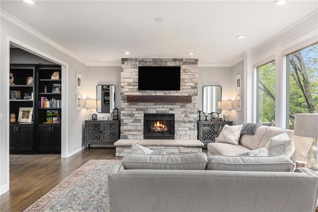 living room featuring dark wood-style floors, crown molding, a fireplace, recessed lighting, and baseboards