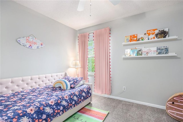 bedroom featuring carpet flooring, a textured ceiling, a ceiling fan, and baseboards