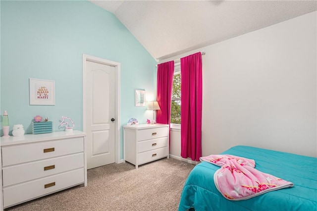 bedroom with light carpet, lofted ceiling, and baseboards