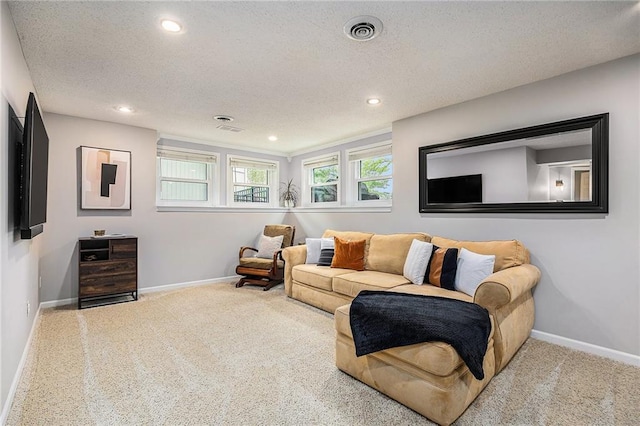 living area with carpet floors, baseboards, recessed lighting, and a textured ceiling