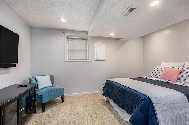 bedroom featuring light colored carpet, a textured ceiling, baseboards, and recessed lighting