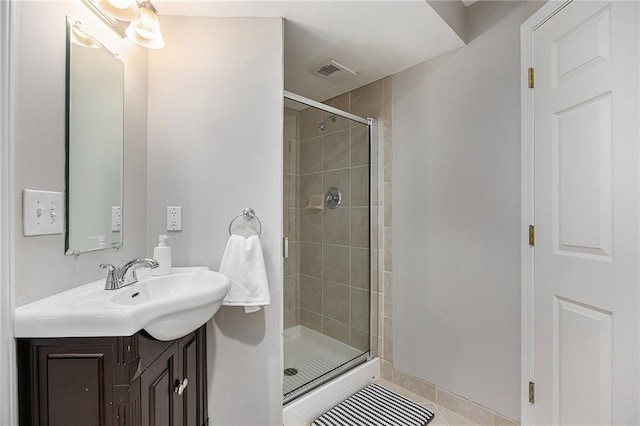 full bath with a shower stall, vanity, and tile patterned flooring