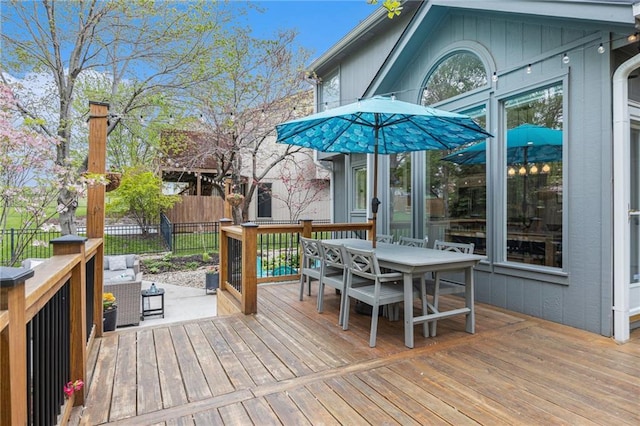 deck featuring outdoor dining space and fence