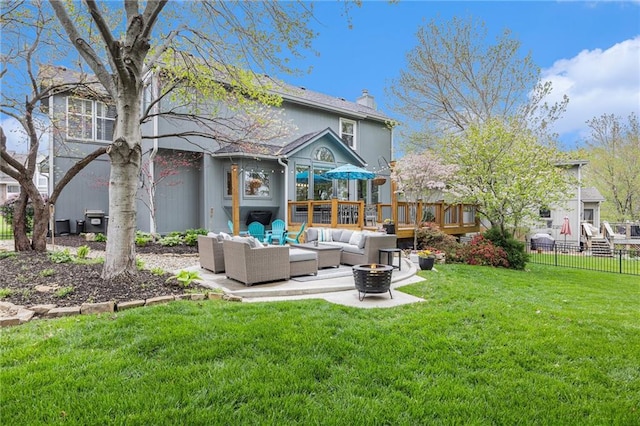 rear view of house featuring an outdoor living space with a fire pit, a patio area, a chimney, and a wooden deck