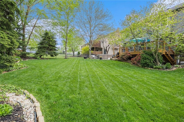 view of yard with stairs and a deck