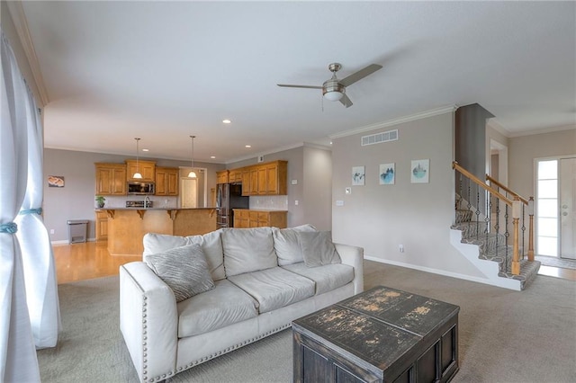 812 SW Stablewood Cir, Lees Summit, MO 64081 - living area with light carpet, ceiling fan, ornamental molding, stairway, and recessed lighting