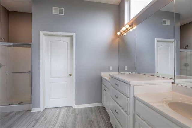 812 SW Stablewood Cir, Lees Summit, MO 64081 - bathroom with wood finished floors, two vanities, and a shower stall