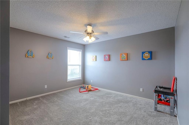 812 SW Stablewood Cir, Lees Summit, MO 64081 - playroom with ceiling fan, carpet, and a textured ceiling