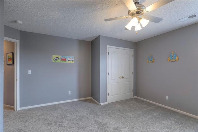 812 SW Stablewood Cir, Lees Summit, MO 64081 - unfurnished bedroom featuring carpet floors, a closet, ceiling fan, and a textured ceiling