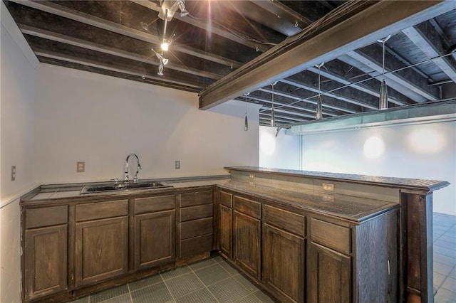 812 SW Stablewood Cir, Lees Summit, MO 64081 - kitchen with dark tile patterned flooring and a peninsula