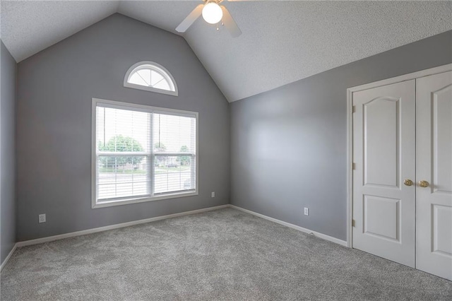 812 SW Stablewood Cir, Lees Summit, MO 64081 - carpeted spare room with ceiling fan, vaulted ceiling, and a textured ceiling