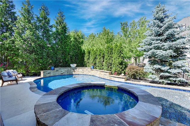 swimming pool with an in-ground hot tub and a patio