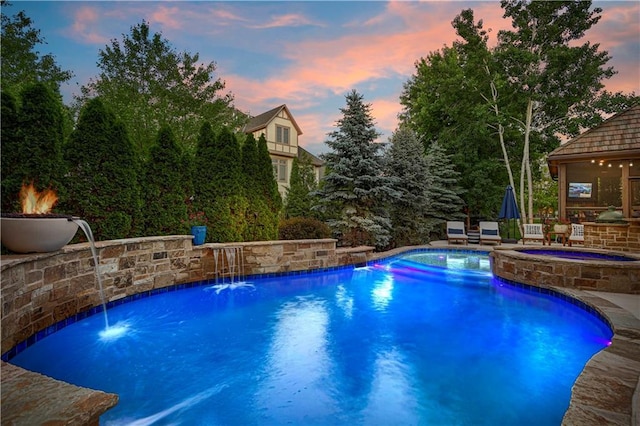view of swimming pool with a pool with connected hot tub and a gazebo