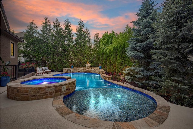 16305 Flint St, Overland Park, KS 66221 - pool at dusk featuring a patio and a pool with connected hot tub