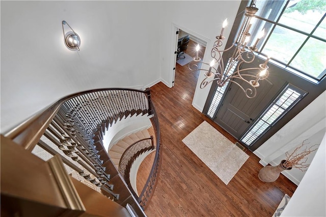 16305 Flint St, Overland Park, KS 66221 - stairway with a chandelier, wood finished floors, and baseboards