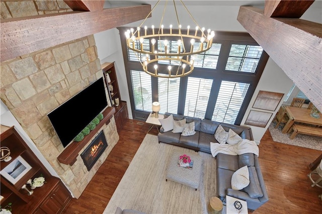 16305 Flint St, Overland Park, KS 66221 - living area with a warm lit fireplace, wood finished floors, plenty of natural light, and a high ceiling