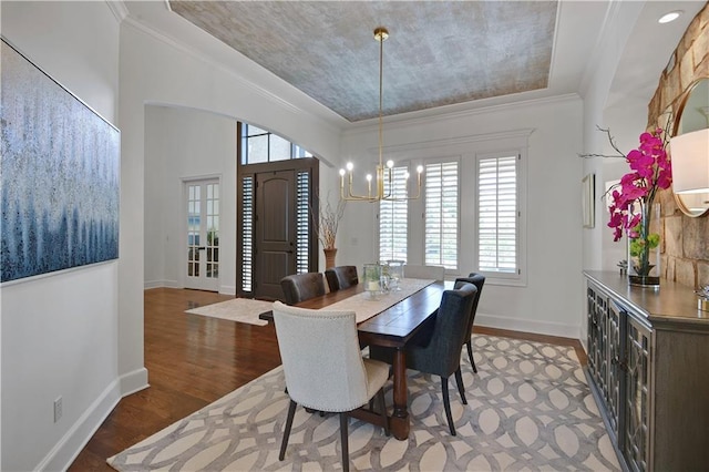 16305 Flint St, Overland Park, KS 66221 - dining area featuring a chandelier, plenty of natural light, wood finished floors, baseboards, and ornamental molding